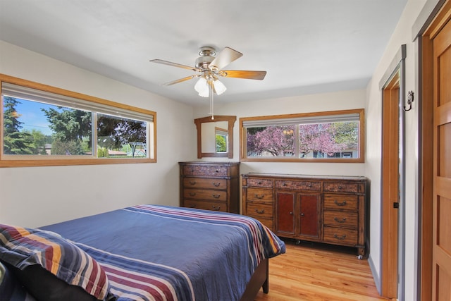 bedroom with light wood-style floors and ceiling fan
