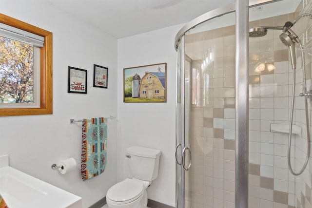 bathroom with toilet and a shower stall