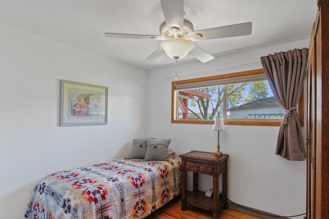 bedroom with ceiling fan and wood finished floors