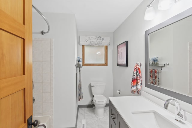 bathroom featuring vanity, marble finish floor, toilet, baseboards, and bathtub / shower combination
