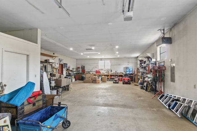garage with a workshop area and a garage door opener