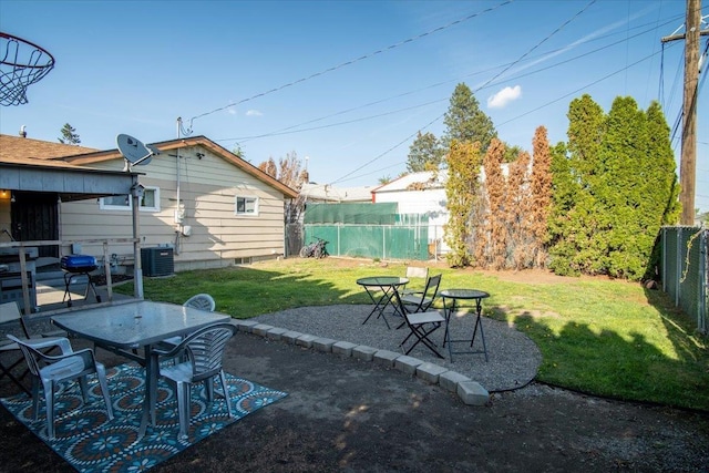 view of yard with a fenced backyard, outdoor dining space, cooling unit, and a patio area