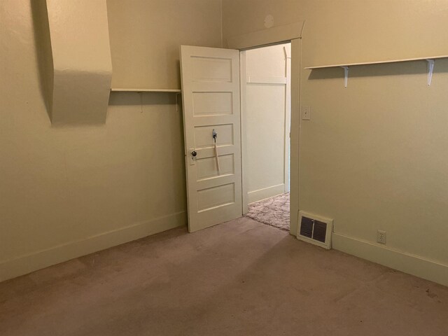 unfurnished room with visible vents, carpet flooring, and baseboards