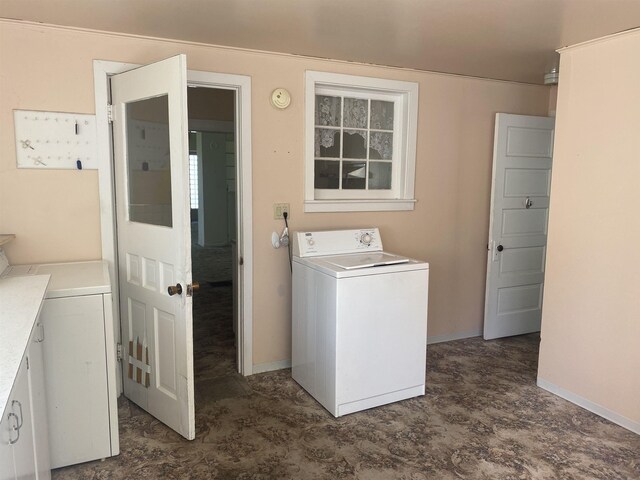laundry room featuring washer / dryer, baseboards, and laundry area