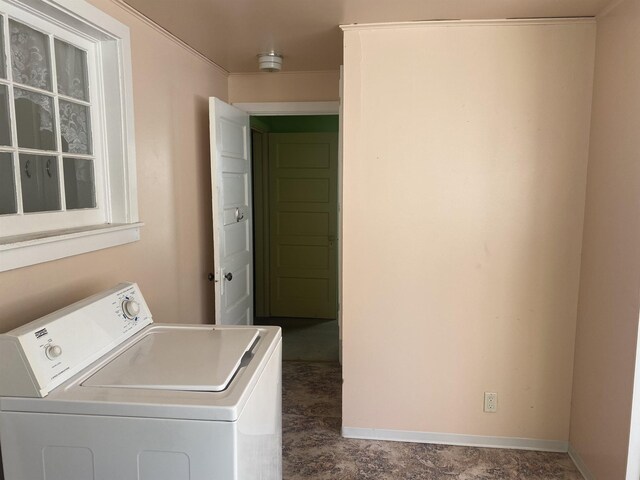 laundry area with laundry area, baseboards, and washer / clothes dryer