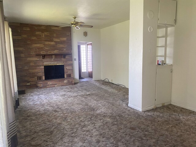 unfurnished living room featuring carpet, ceiling fan, and a fireplace