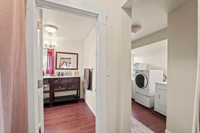 laundry room featuring laundry area, dark wood-style flooring, and washing machine and dryer