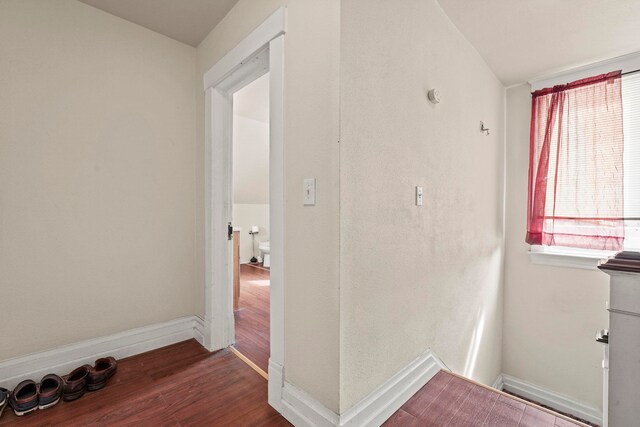 interior space with baseboards and wood finished floors