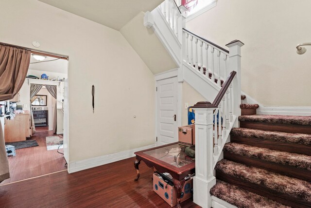 stairway featuring baseboards and wood finished floors