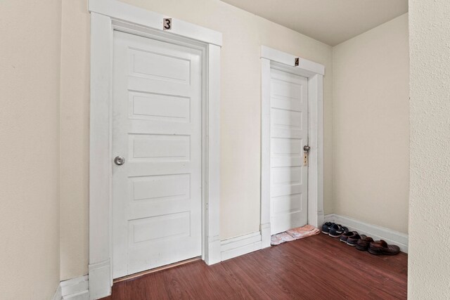 interior space with baseboards and wood finished floors