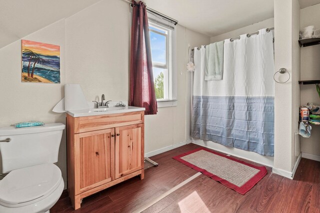 bathroom with vanity, shower / tub combo with curtain, wood finished floors, and toilet