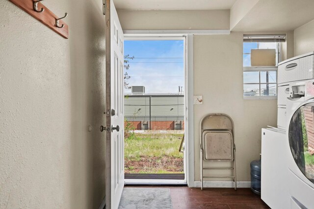 laundry room featuring baseboards, laundry area, and dark wood-type flooring