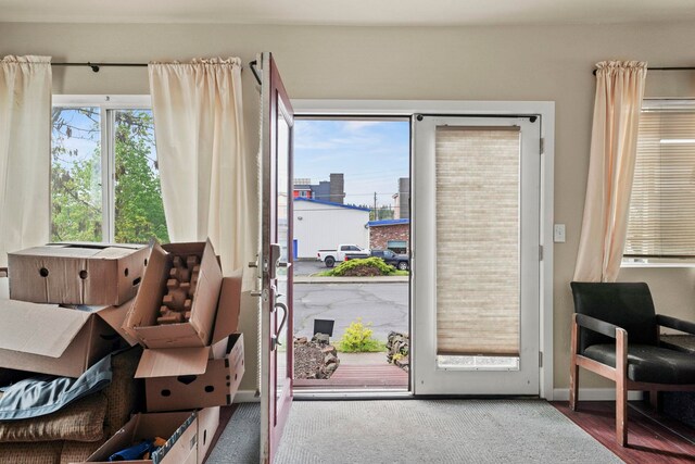 doorway to outside featuring baseboards
