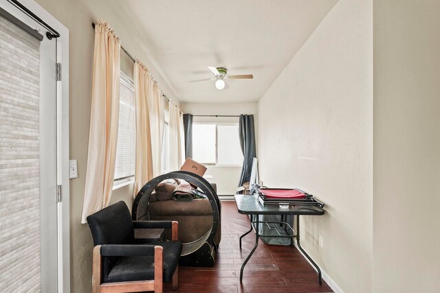sitting room featuring baseboards, a ceiling fan, and wood finished floors