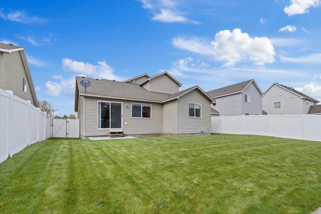 14316 E 31st Ln, Veradale, WA 99037 - back of property featuring a yard, a fenced backyard, a gate, and entry steps