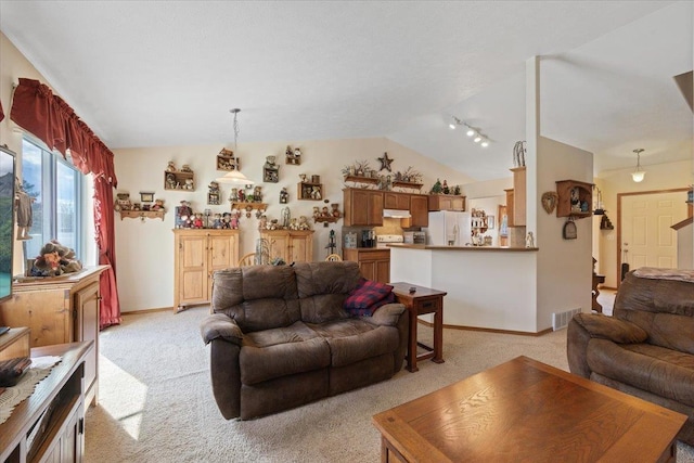 14316 E 31st Ln, Veradale, WA 99037 - living area featuring visible vents, light colored carpet, rail lighting, baseboards, and lofted ceiling