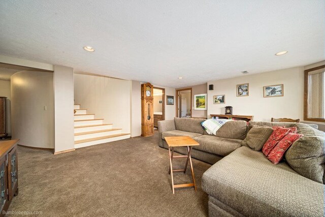 living area with carpet floors, recessed lighting, visible vents, and stairway