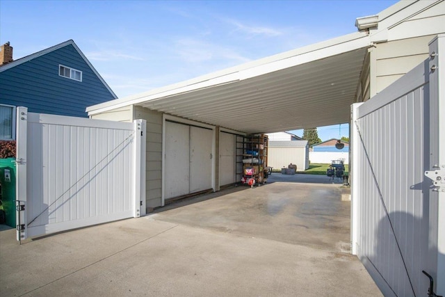 view of parking / parking lot with a gate and an attached carport