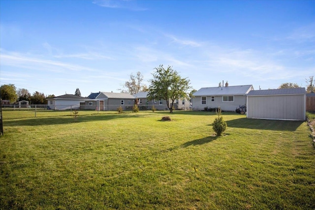 view of yard featuring a storage shed, an outbuilding, and a fenced backyard