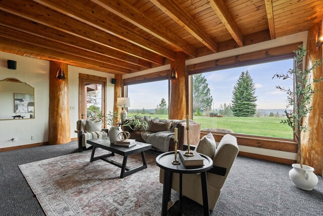 carpeted living area with baseboards, wood ceiling, and beamed ceiling