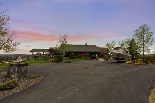 single story home with aphalt driveway