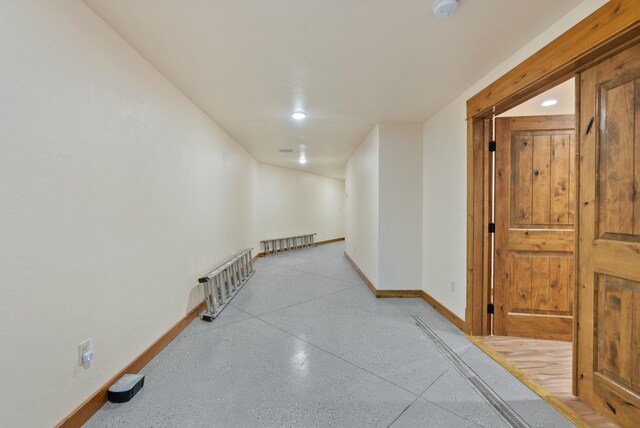 hallway with baseboards and recessed lighting