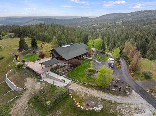 drone / aerial view with a forest view and a mountain view