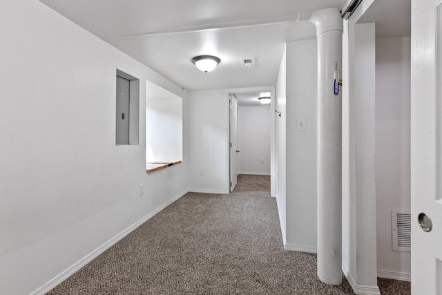 corridor featuring visible vents, baseboards, carpet floors, and electric panel
