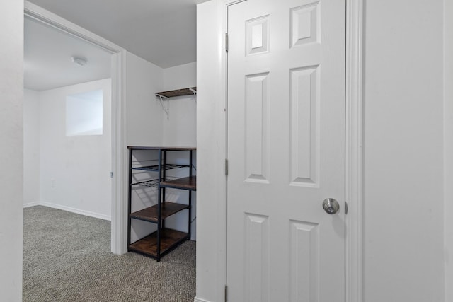 interior space featuring carpet flooring and baseboards