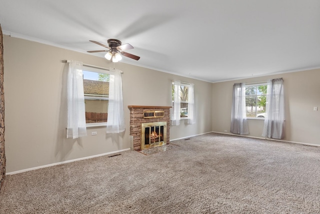 unfurnished living room with crown molding, ceiling fan, visible vents, and a wealth of natural light