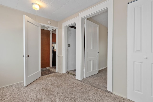 interior space with baseboards, carpet flooring, and a closet