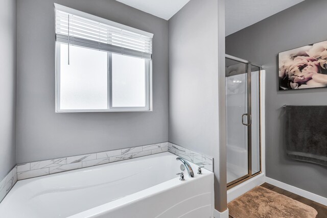 bathroom featuring a shower stall, wood finished floors, and a bath