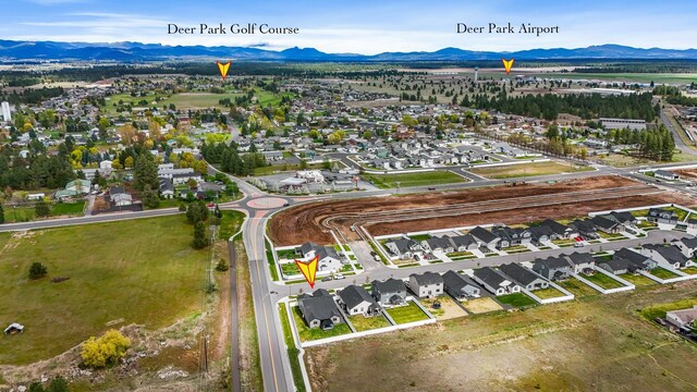 drone / aerial view featuring a residential view and a mountain view