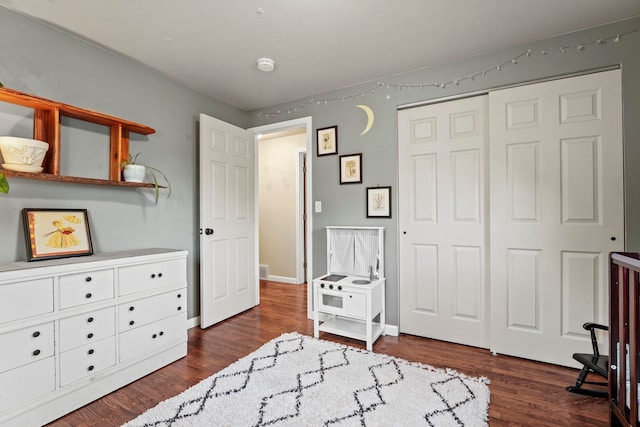 bedroom featuring a closet and dark wood finished floors