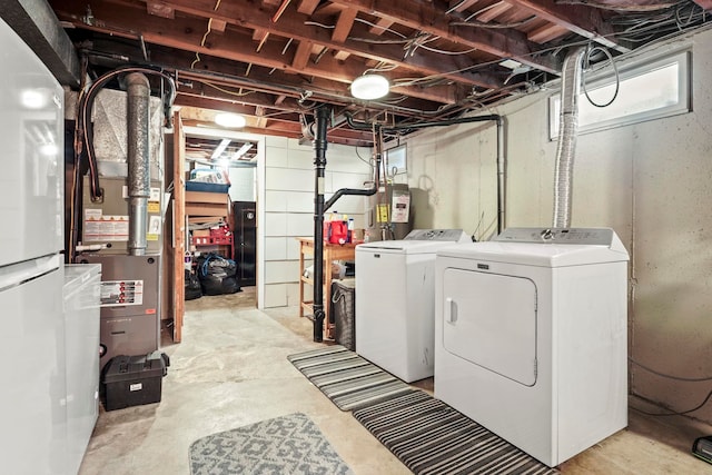 basement with washer and clothes dryer and electric water heater