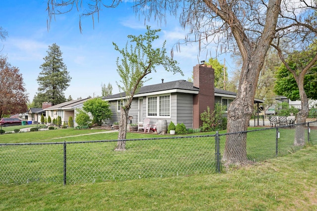 ranch-style home featuring a chimney, fence private yard, and a front yard