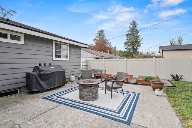 view of patio / terrace with an outdoor fire pit, fence, and area for grilling