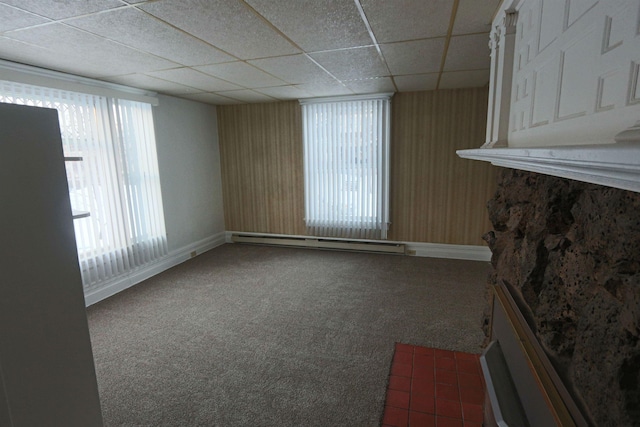 unfurnished living room with carpet floors, baseboards, a paneled ceiling, and baseboard heating