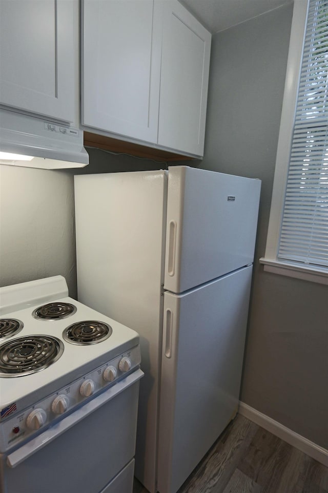 kitchen featuring baseboards, ventilation hood, white cabinets, white appliances, and dark wood-type flooring