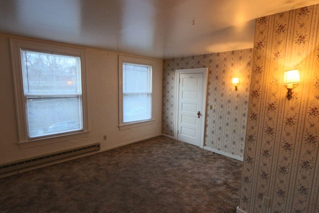 spare room with carpet floors, baseboards, and baseboard heating