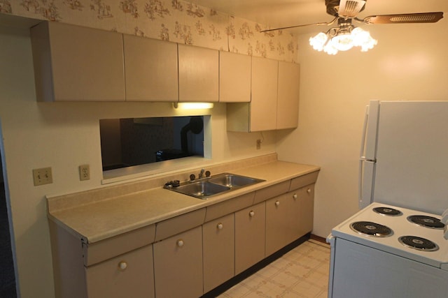 kitchen with ceiling fan, a sink, light countertops, light floors, and white appliances