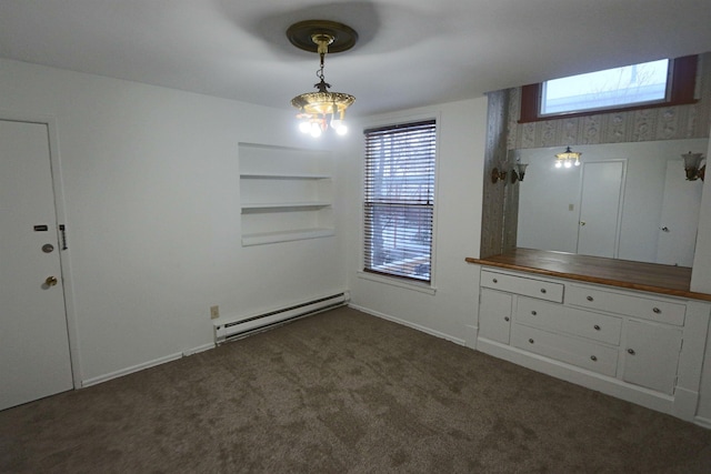 unfurnished dining area with carpet floors, baseboards, built in shelves, and baseboard heating