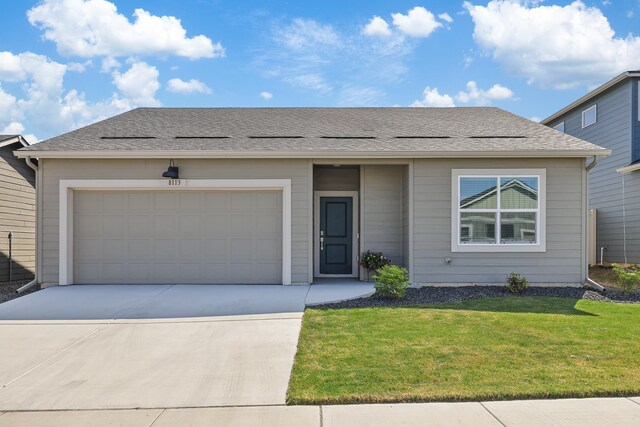 view of front facade with a garage, driveway, and a front yard