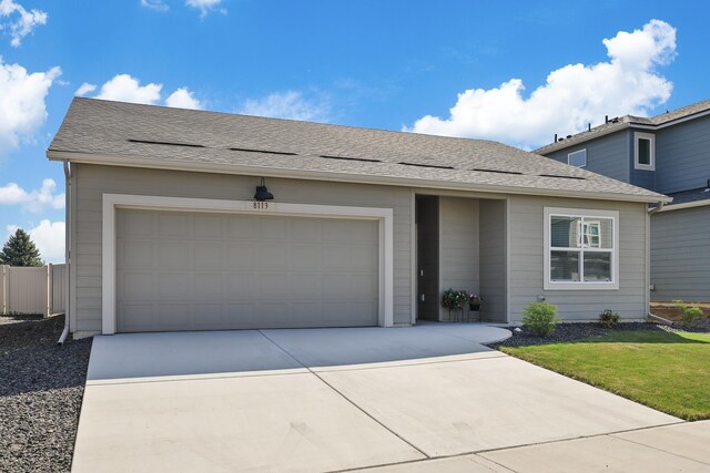 single story home featuring an attached garage and driveway
