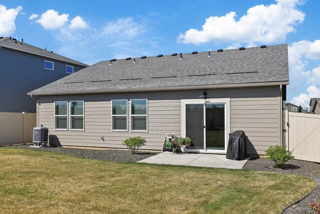 back of property featuring a lawn, a patio, and fence