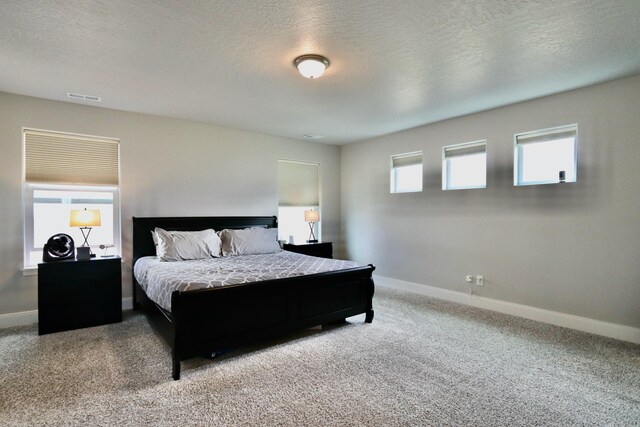 bedroom with carpet flooring, baseboards, and visible vents