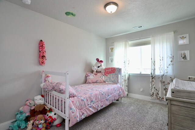 carpeted bedroom featuring visible vents and baseboards