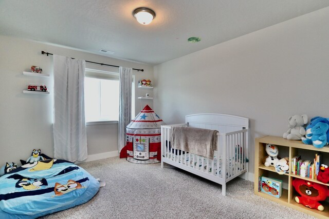 carpeted bedroom featuring visible vents and baseboards