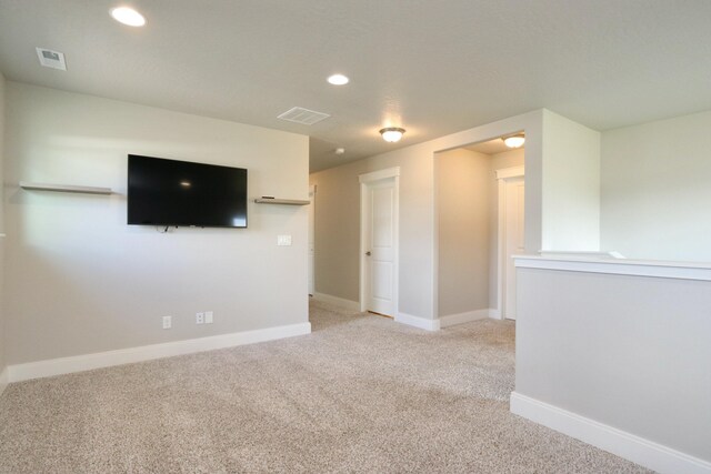 interior space featuring visible vents, recessed lighting, and light carpet