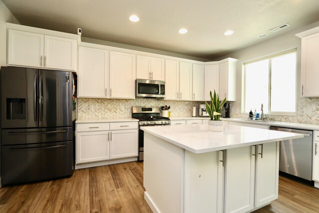 kitchen featuring a sink, white cabinetry, and appliances with stainless steel finishes